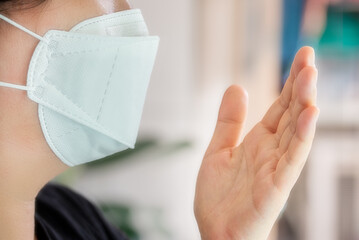 A woman wearing a mask to prevent a virus attack.