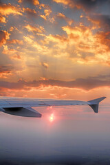 The view from the window of the plane. The wing of the plane, the sun under the wing. Beautiful sunrise