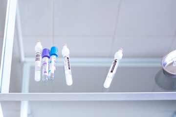 empty plastic blood collection tubes for analysis on a glass treatment table, diagnosis of coronavirus, disease