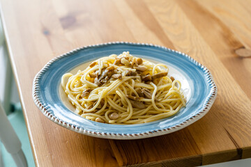 Homemade Spaghetti with Mushroom and Cream Sauce on Rustic Wooden Table .