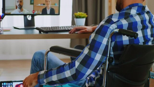 Disabled entrepreneur in wheelchair during a video conference. Handicapped invalid paralysed freelancer, immobilized entrepreneur working from home, ilness and disability