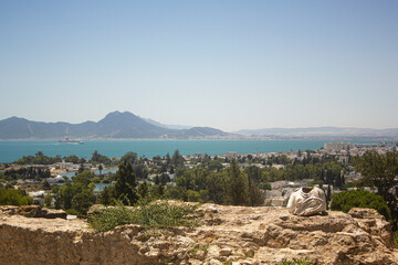 Ancient ruins at Carthage, Tunisia with the Mediterranean Sea. View from hill Byrsa with ancient remains of Carthage and landscape. Tunis, Tunisia.
