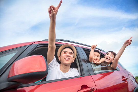 Happy Asian Family On  Road Trip In The Car