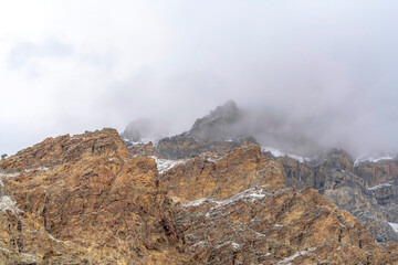 Misty clouds over the rugged and rocky slope of Provo Canyon mountain in Utah