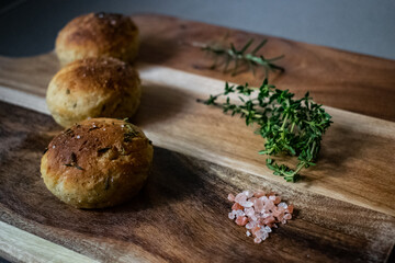 Obraz na płótnie Canvas Baked bread rolls with herbs and salt.
