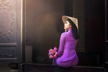 Beautiful vietnamese woman in Ao Dai white-traditional dress of vietnam, Ho Chi Minh city Vietnam - obrazy, fototapety, plakaty