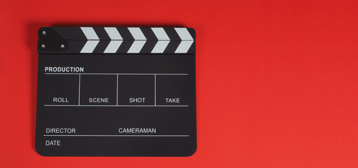 Fototapeta na wymiar Clapper board or clapperboard or movie slate .It is use in video production ,film, cinema industry on red background.
