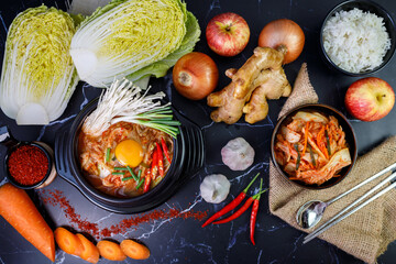 Kimchi cabbage soup in a bowl with materials of the kimchi on black background