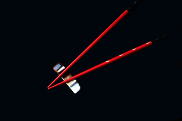 red chopsticks and stand on a black background
