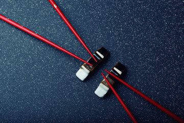 chopsticks and stand on a dark blue background