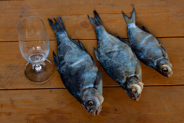 dried fish on a wooden table. breams. vobla. beer snack