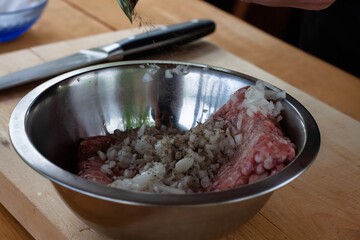 mixing minced meat with spices for cutlets. cooking burgers.