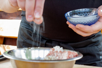 mixing minced meat with spices for cutlets. cooking burgers.