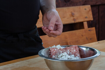 mixing minced meat with spices for cutlets. cooking burgers.