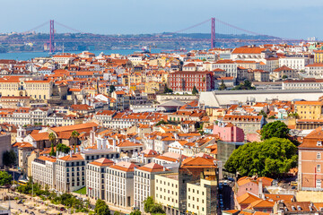 Fototapeta na wymiar View to downtown of Lisbon with miltiple streets and houses and bridge of 25 of April in a background, Portugal