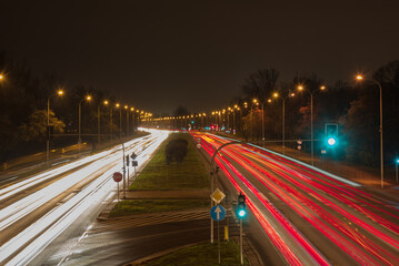 Fototapeta na wymiar Car moving on highway against dark night, photograph is taken with long exposure. 
