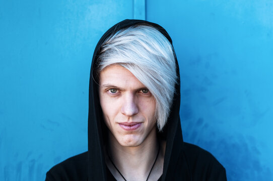 Portrait Of Young Man With Silver Colored Hair And Dressed In A Black Hoodie.