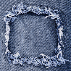 Denim jeans cloth in trendy used look design. Bleached scratched fabric backdrop 