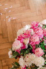 bouquets of peonies on wooden background