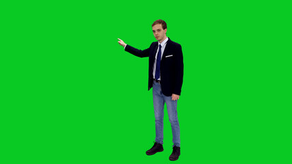 Young stylish businessman in suit jacket standing and presenting something on green screen...