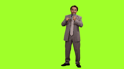 News reporter doing live piece to camera on green background, Chroma key