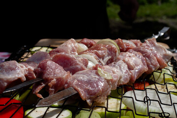 fresh pork meat on a skewer. preparation of a shish kebab.