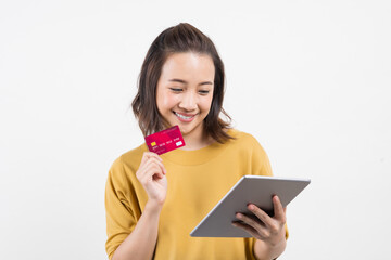 Naklejka premium young woman using her digital tablet and credit card to bring joy to the world