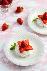 top view strawberry meringue nests with mint on a plate