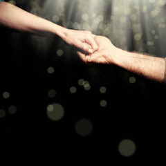close up senior adult male hand and young adult female hand holding each other