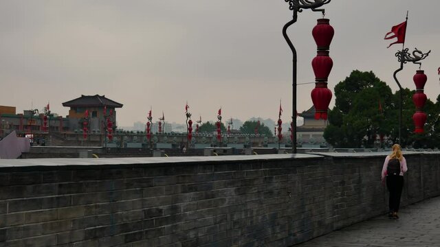 Blond woman is enjoying visiting old Chinese city Xian