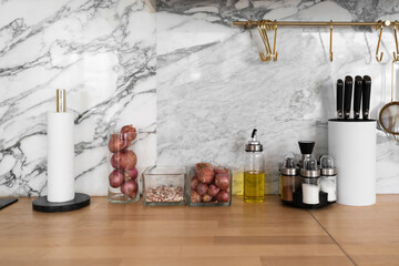 Modern classic kitchen interior with kitchen appliances and raw ingredients on wood top with marble wall in the background / kitchen interior