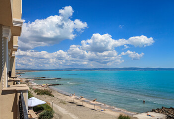 Fototapeta premium View from the hotel balcony to the Bulgarian Black Sea coast. Summer sunny day, beautiful clouds in the sky. Summer vacation concept.