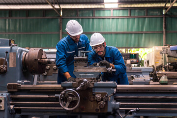 Professional technicians and two engineers are working in industrial plants. Professional...