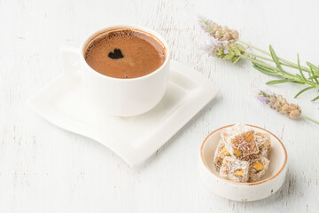 cup of coffee and turkish delight on wooden table