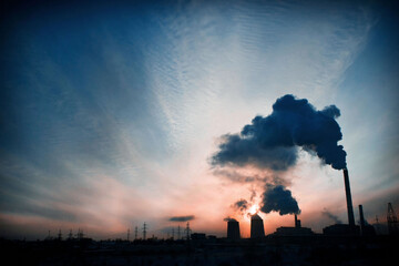thermal power plant against the sunset and blue sky