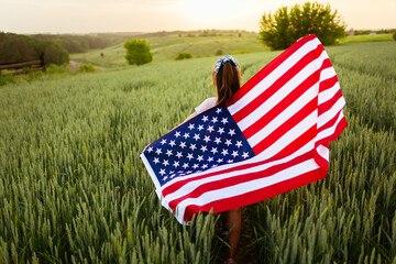 Independence day concept with woman lying down on american flag