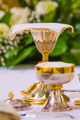 chalice with wine, blood of christ, and pyx with bread, body of christ, ready for the communion of the faithful