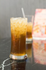 glass of ice tea blur background