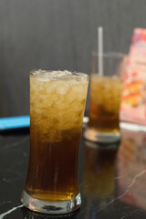 glass of ice tea blur background