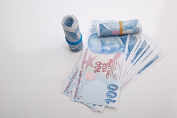 Turkish banknote composition of 100 TL on a white background.