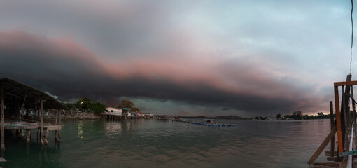Image of traditional fisherman jetty during windy and dark cloudy day