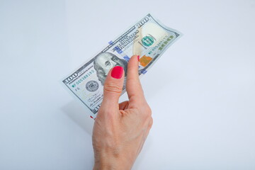 Usd banknote view in female hand on white background.