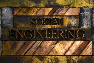Social Engineering text formed with real authentic typeset letters on vintage textured silver grunge copper and gold background