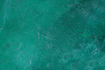 The green abstract surface of a concrete wall with rough surfaces old and dirty condition