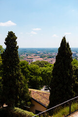 Fototapeta premium Aerial view of the historical center of Brescia (Lombardy, Italy) with tiled red roofs, chimneys, cathedral's domes and tall white brick old towers. Traditional European medieval architecture. 