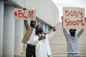 Portrait of three men protesting