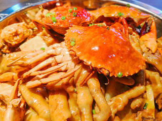 Delicious crab meat and chicken feet in clay pot.