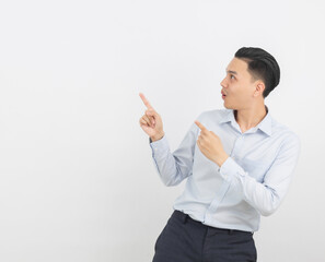 Young asian business man with blue shirt pointing to the side with a hand to present a product or an idea isolated on white background.