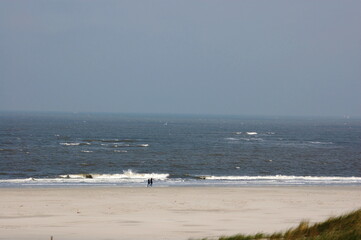 Walking on the Beach with Wind and Waves