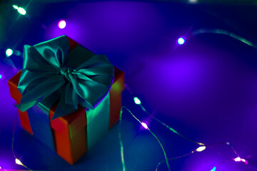 red gift box with blue ribbon on a blue background